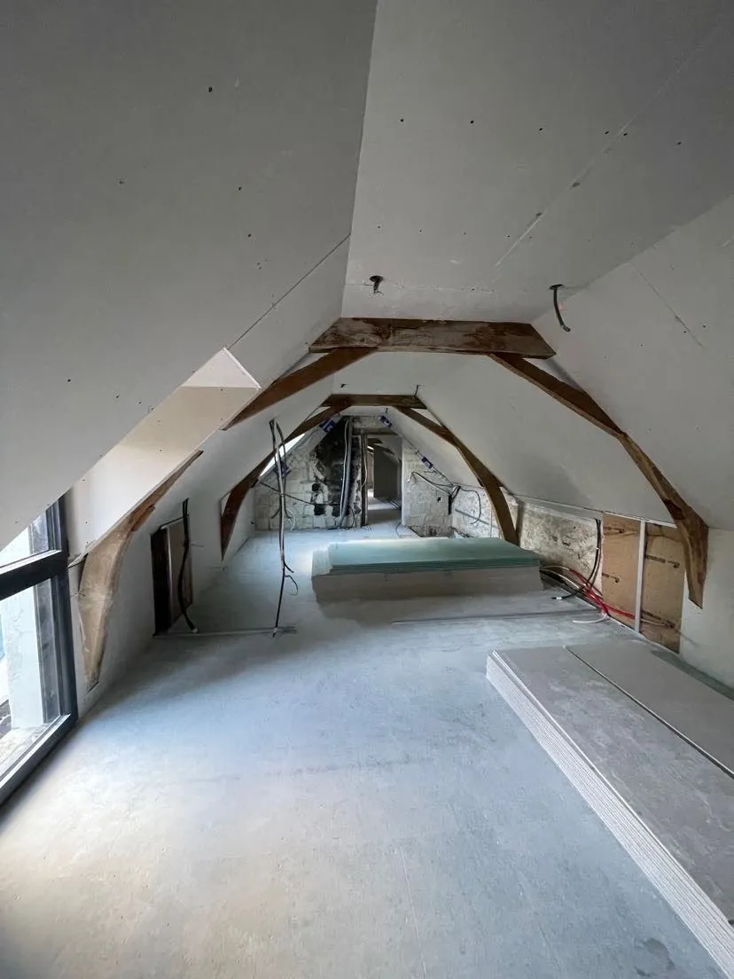 Rénovation de combles conservant la charpente ancienne apparente